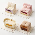 Cross section of a Cozy Companions mini mousse cake showing mousse, cake sponge, filling, and layered dessert structure.
