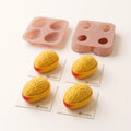 Golden Mango silicone mold set displayed with finished mango-shaped mousse cakes