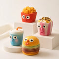Finished Joyful Snackland mini mousse cakes in burger, fries, soda, and popcorn shapes.