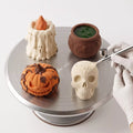 Halloween mousse cakes finished with velvet spray in ivory, orange and black to highlight their sculpted details.