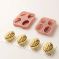 Pistachio silicone molds displayed with finished pistachio-shaped mousse cakes