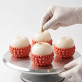 Close up detail of gold dust decoration on a Sweet Lychee mousse cake